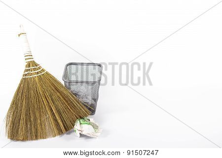 isolated besom and wastebasket with white waste paper