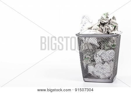 isolated wastebasket full of newspaper waste paper