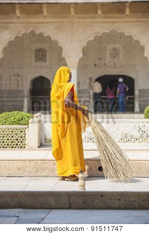Woman Of Fourt Class In Brightly Colored Clothing Cleans The Palace In Amber