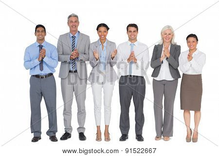 Smiling business people applauding on white background