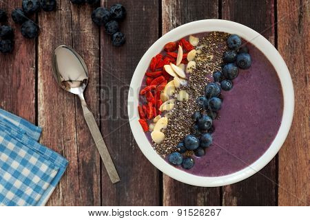 Blueberry smoothie bowl on a rustic wood table