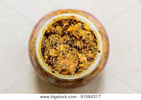 Indian pickle made from raw jackfruit kept in a vessel on plain background