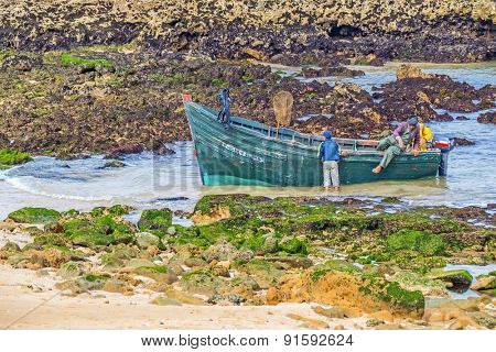 OUALIDIA, MOROCCO, APRIL 6, 2015: Fishermen prepare their boat to go fishing 