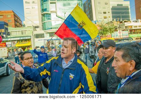 Quito, Ecuador - April 7, 2016: Closeup opposition leader Andres Paez surrounded by people, police and journalists during anti government protests in Shyris Avenue.