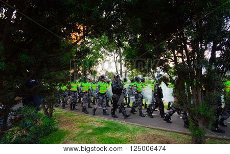 Quito, Ecuador - April 7, 2016: Police leaving marching peaceful anti tax march in Shyris Avenue with anti Rafael Correa goverment protestors.