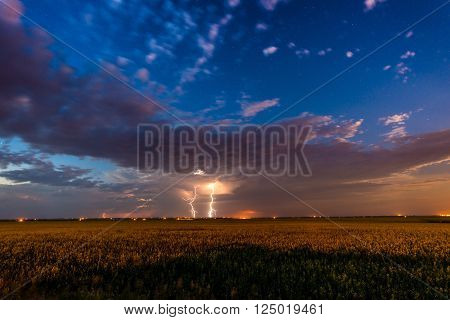 Lightning over a farm field during the summer in alberta