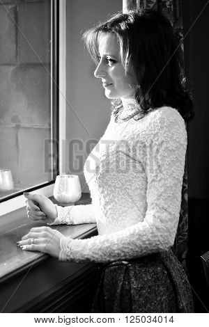 Loneliness Woman at window black & white