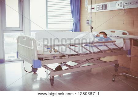 Asian Boy Lying On Sickbed With Saline Intravenous (iv). Health Care And People Concept.