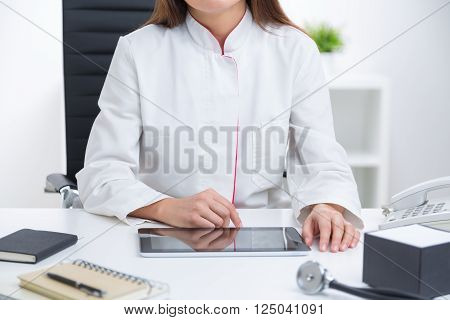 Female Doctor Sitting At Desk