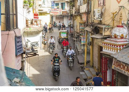 UDAIPUR INDIA - 20TH MARCH 2016: A view along streets of Udaipur in the Rajastan district of India. Lots of people and traffic can be seen.