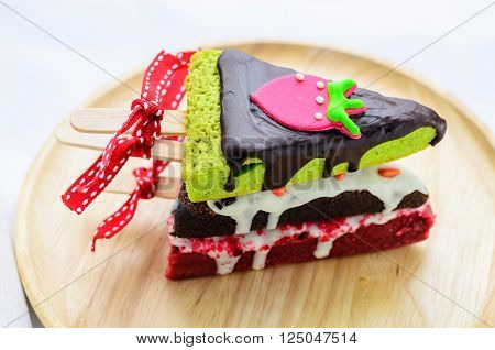 Home made brownies winter tree shape with red bow and ribbon on wooden plate