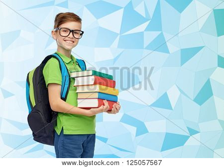 childhood, school, education and people concept - happy smiling student boy in eyeglasses with school bag and books over blue low poly texture background