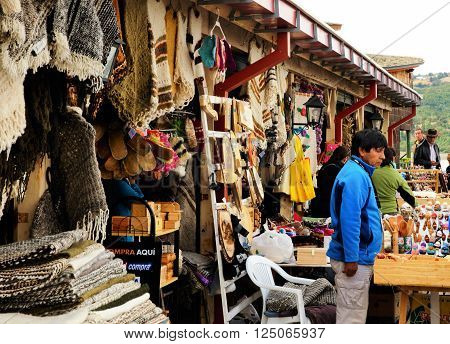 DALCAHUE, CHILE - MARCH 13, 2016: Man is selling his products on a craft fair on March, 13, 2016 in Dalcahue, Chile.