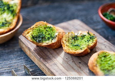 Garlic bread with wild garlic bread on a rustic background