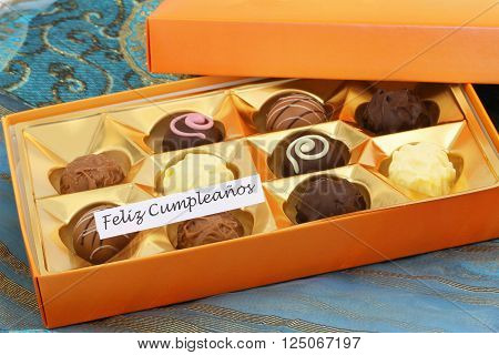 Feliz cumpleanos (which means happy birthday in Spanish) card with box of assorted chocolates