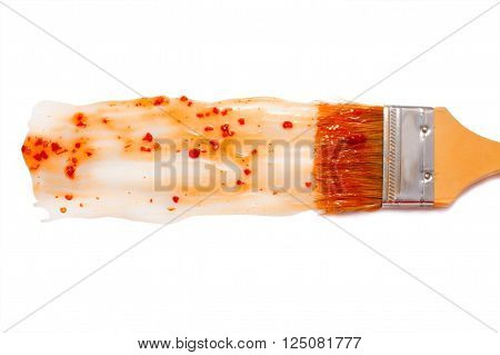 paint brush and dab of sweet and sour sauce. sour-sweet sauce. texture. sample and brush isolated on white background