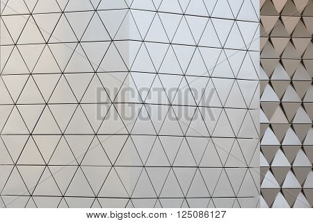 Abstract close-up view of modern aluminum ventilated facade of triangles