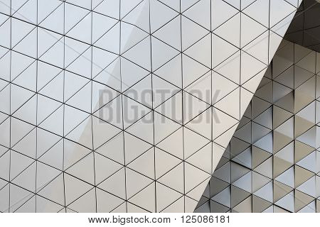 Abstract close-up view of modern aluminum ventilated facade of triangles
