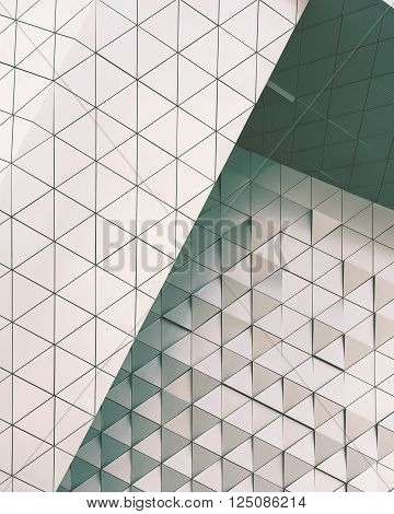 Abstract close-up view of modern aluminum ventilated facade of triangles