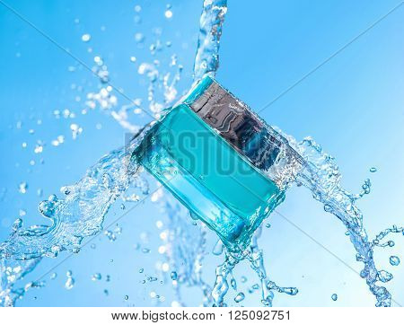 The blue  jar of moisturizing cream with big water splash around the jar  on the blue gradient background
** Note: Visible grain at 100%, best at smaller sizes