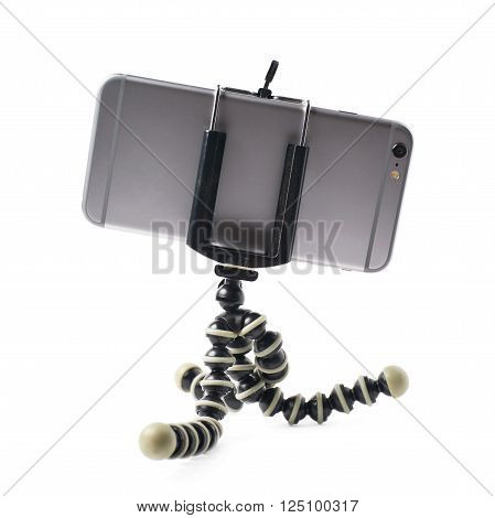Smartphone set up on a tripod isolated over the white background