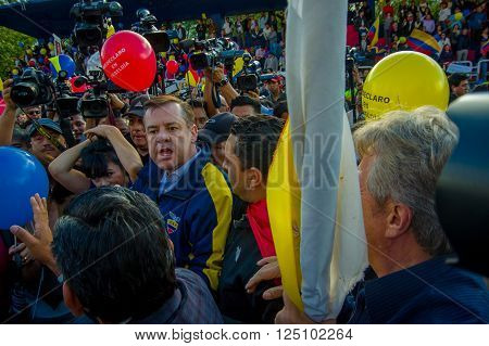 Quito, Ecuador - April 7, 2016: Closeup opposition leader Andres Paez surrounded by people, police and journalists during anti government protests in Shyris Avenue.