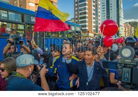 Quito, Ecuador - April 7, 2016: Closeup opposition leader Andres Paez surrounded by people, police and journalists during anti government protests in Shyris Avenue.