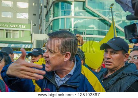 Quito, Ecuador - April 7, 2016: Closeup opposition leader Andres Paez surrounded by people, police and journalists during anti government protests in Shyris Avenue.