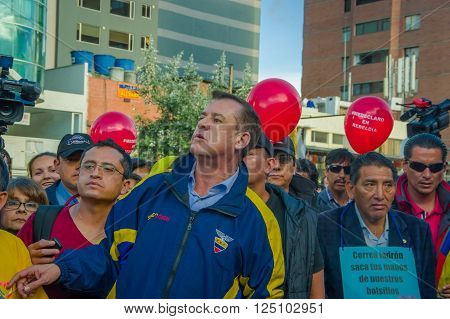 Quito, Ecuador - April 7, 2016: Closeup opposition leader Andres Paez surrounded by people, police and journalists during anti government protests in Shyris Avenue.