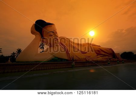 Reclining Buddha in the sunset. Bago, Myanmar.