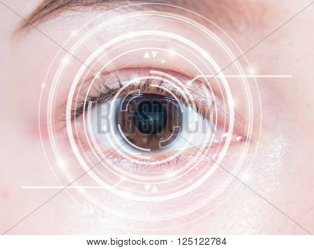 Close-up of woman's brown eye. High technology in the futuristic. scan, contact lens