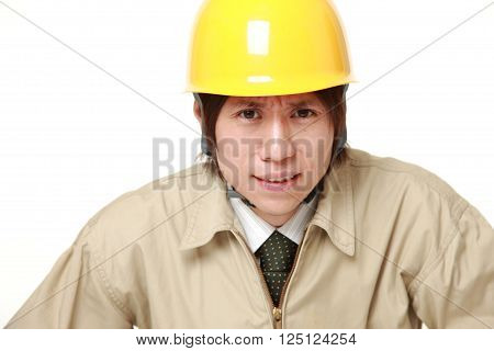portrait of perplexed construction worker on white background
