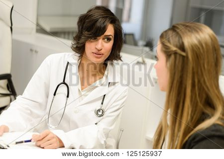 Female doctor explaining diagnosis to her female patient