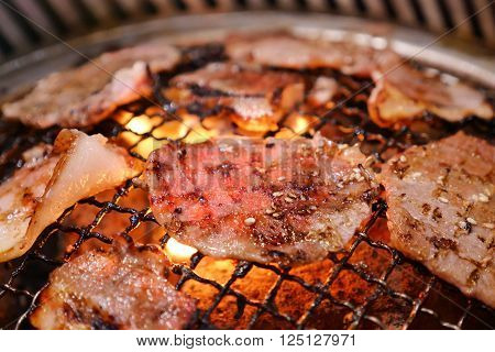 Pork grill on hot coals. This kind of food is a Korean or Japanese BBQ style.