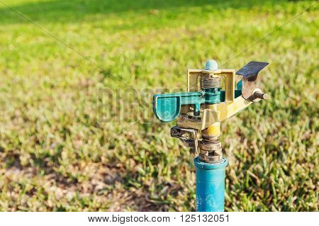 Water tab on blurred green grass Selective focus
