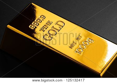 closeup of gold bullion on a dark background