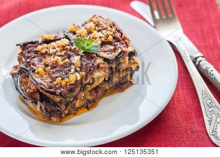 Portion of Parmigiana di melanzane on the white plate