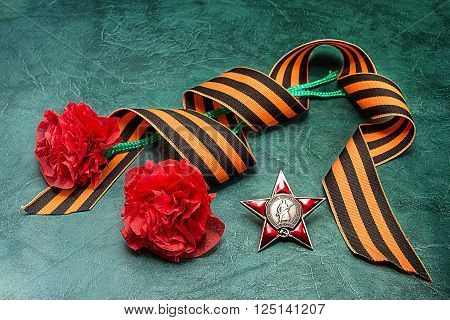 George ribbon order of red star and self-made carnations. Postcard to the Day of Victory. May 9/ Russian translation: proletarians of all countries unite! The USSR