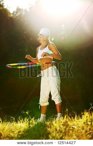 woman rotates hula hoop