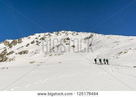 Zakopane Poland - March 28 2016: Hikers on the approach to the summit in the Polish Tatra mountains in winter conditions.