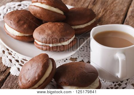 Chocolate Whoopie pie and coffee with milk close-up. horizontal