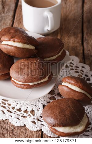American Dessert Chocolate Whoopie Pie And Coffee Close-up. Vertical