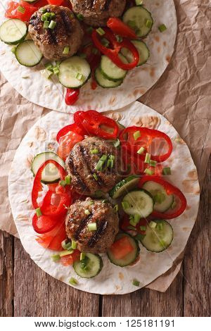 Grilled Meat Balls With Fresh Vegetables On A Flat Bread Close Up. Vertical Top View