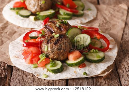 Grilled Meat Balls With Fresh Vegetables On A Flat Bread Close Up. Horizontal