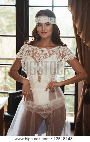 Beautiful sexy girl in boudoir white dress