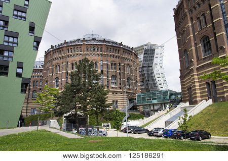 VIENNA AUSTRIA - MAY 7: Modern buildings in front of Gasometers of Vienna in Austria on 7 May 2012 in Vienna Austria.
