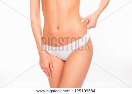 Close Up Portrait Of Fit Woman Checking Fat On Her Side