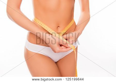Close Up Photo Of Slim Fit Woman Measuring Her Waist