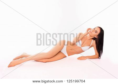 Pretty Slim Woman Lying In White Underwear On White Background