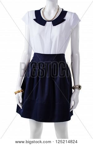 Mannequin wearing short sleeve blouse. White blouse with navy collar. Elegant blouse and wrist accessories. Lady's light top and watch.